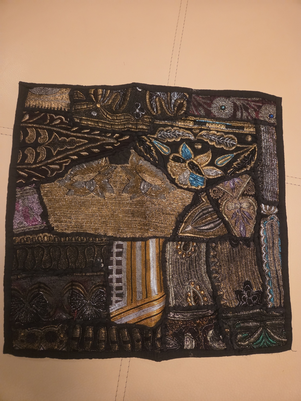 Decorative patchwork pillow cover featuring metallic embroidery, beadwork